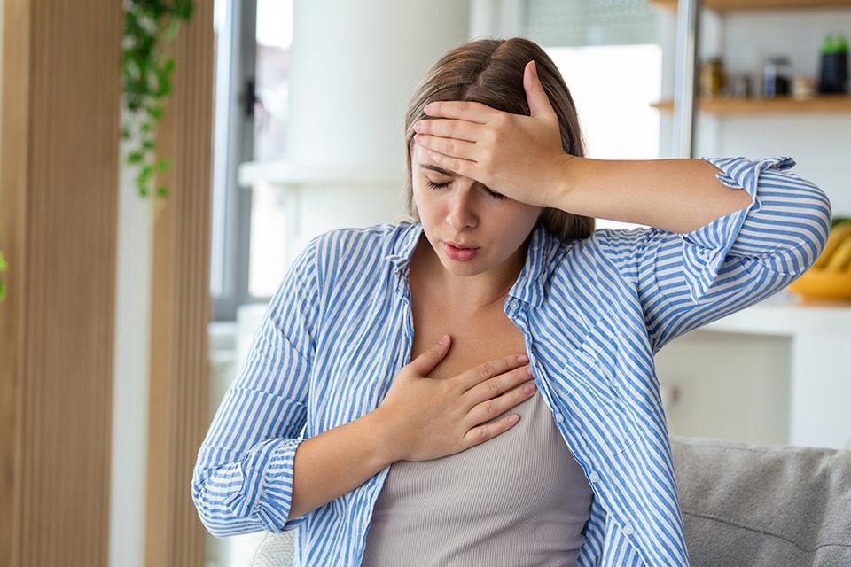 Breathing, respiratory problem, asthma attack, pressure, chest pain, sun stroke, dizziness concept. portrait of woman received heatstroke in hot summer weather, touching her forehead