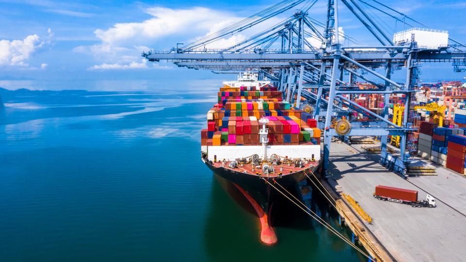 Container cargo ship at industrial port in import export business logistic and transportation of international by container cargo ship in the open sea.